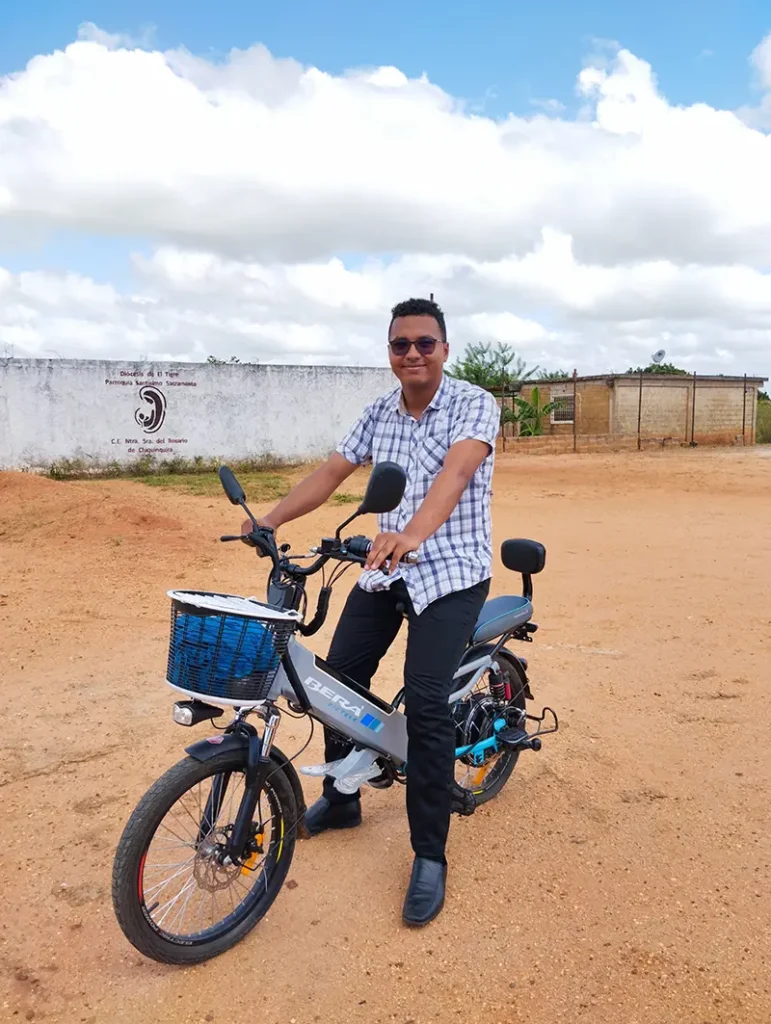 Leonardo poses on a motorcycle in his hometown in Venezuela, while thinking about God.
